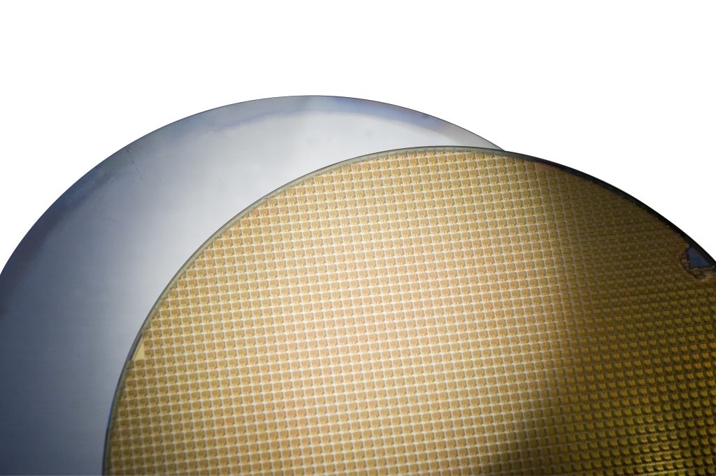 Close-up of bonded semiconductor wafers being separated during laser debonding in the semiconductor market.