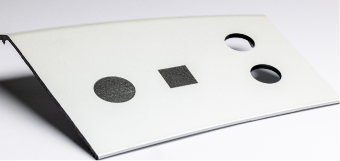 Precise laser ablation on automotive parts with clean circular and square surface preparation.