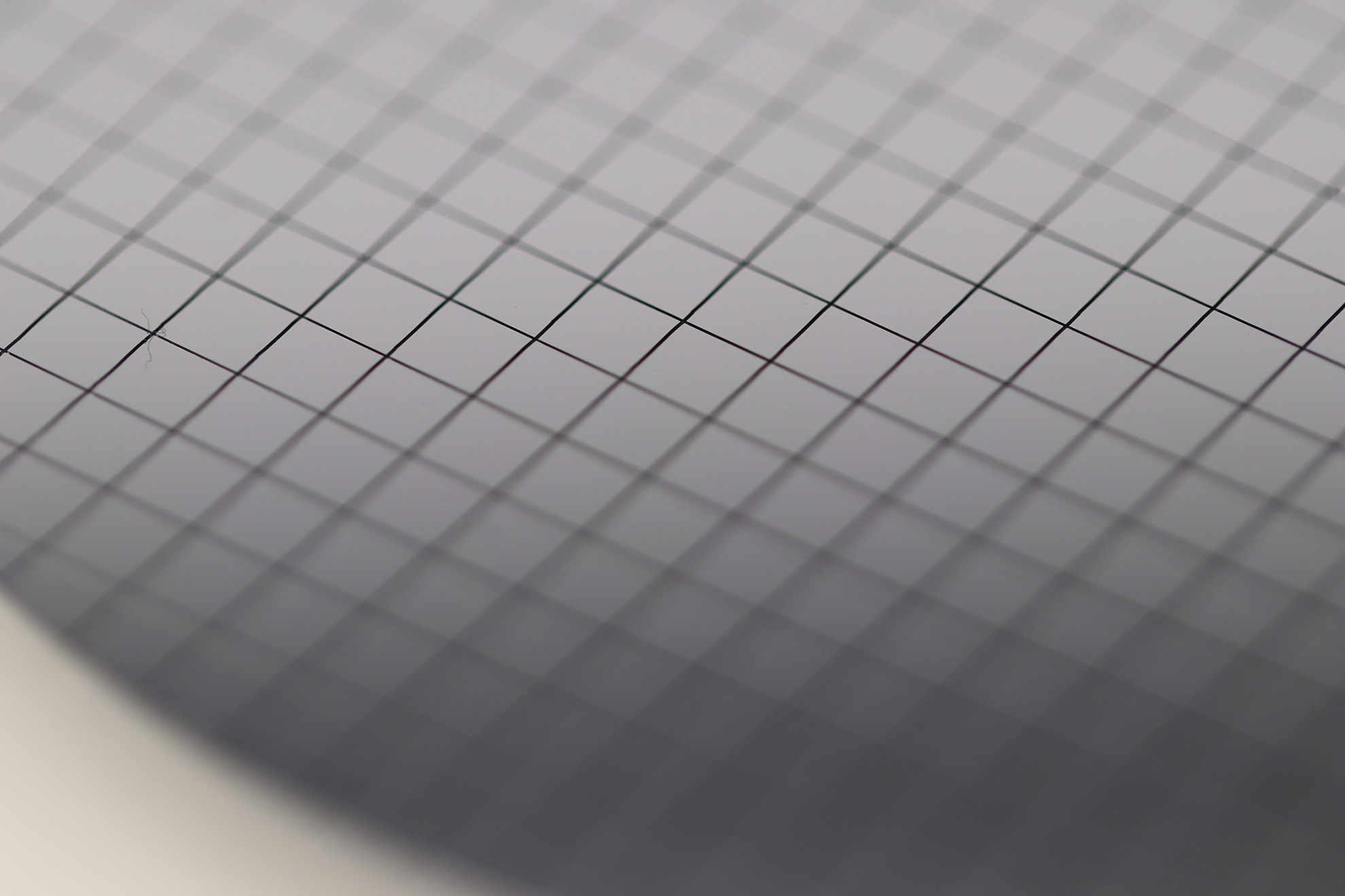 Close-up of a patterned semiconductor wafer for laser dicing in the semiconductor market.